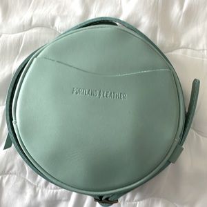 Portland Leather small circle crossbody bag. Brand new